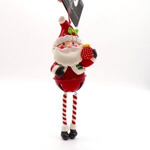 The Christmas Shoppe Santa Ornament 2023 Resin Metal Bell Dangling Legs 7" NWT